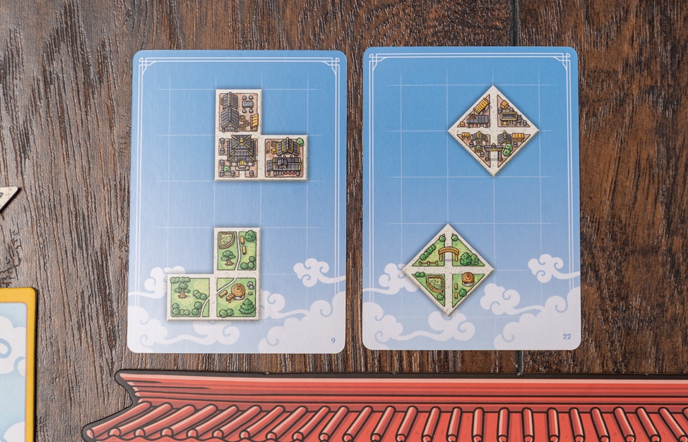 Tangram City board game completed city designs