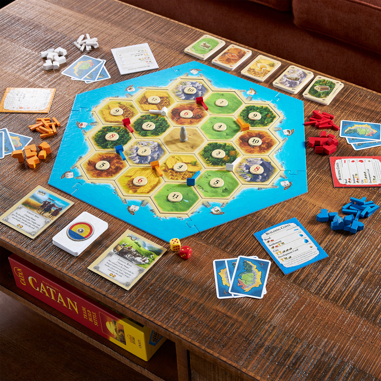 Catan complete game components with dice, development cards, and player pieces