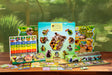 Educational game set with animal-themed cards and board on a wooden table.