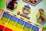 Board game with hexagonal cards featuring animals and a building, with 'Feuerland' branding.