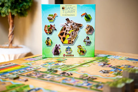 Board game box for 'Sanctuary' on a table with game pieces.