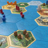 Catan: Explorers and Pirates board game gameplay setup with islands